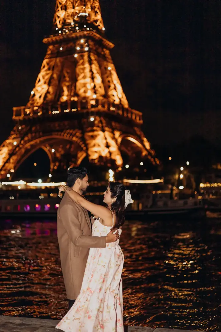 Couple Eiffel Tower night Seine river lights Paris
